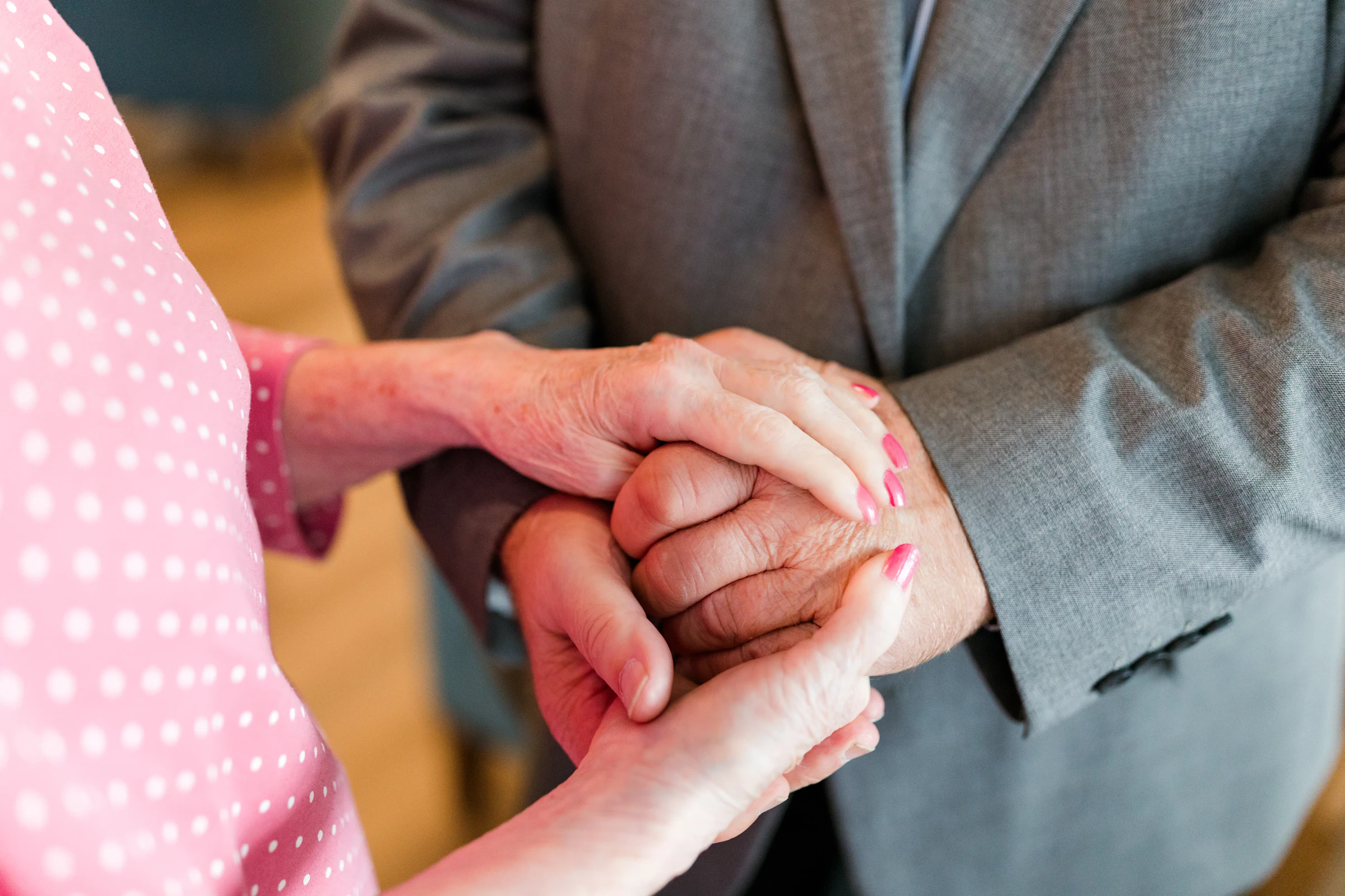 Older couple holding hands